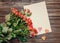 Blank sheet of paper on wooden surface with roses