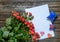 Blank sheet of paper on wooden surface with roses