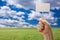 Blank Sign in Fist Over Grass Field and Sky