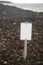 Blank Sign on Rock Beach