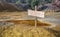 Blank sign on top of chemical waste pile in abandoned mine pit