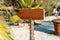 Blank signpost board on the summer beach. Empty wooden information guidepost on the way. Destination, choice concept