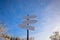 Blank signpost with three white arrows against beautiful blue sky in sunny frozen day. Blank track pointers or guide post on