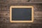 Blank small chalkboard on an old rustic background, close up