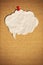 Blank speech bubble with push pin on cork board