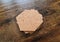 Blank stack coaster mockup with cork texture on wooden surface. Hexagonal drink pad pile template