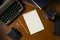 Blank steno notepad on a desk among vintage journalism props