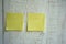 Blank sticky note pasted on a white wooden wall