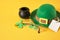 blank tag, glasses, coins, leprechaun hat and clover leaves on yellow background, st. patrick's day concept, save