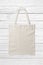 Blank Tote Canvas Bag Mockup on white wooden background.