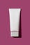 Blank tube with box mock up design. Close up of beauty hygiene container on pink background with shadow. Cosmetic productshot
