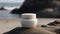 Blank, unbranded cosmetic cream jar standing on the beach. Skin care product presentation. Skincare, beauty. Jar with