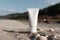 Blank, unbranded cosmetic cream tube standing on the beach. Skin care product presentation. Skincare, beauty. Tube with