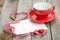 Blank valentines greeting card and red coffee cup