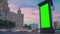 Blank vertical advertising green billboard poster, pillar; gets dark - timelapse