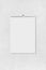 Blank vertical paper sheet of notebook hanging on abstract wall