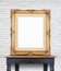 Blank vintage golden photo frame lean at white brick wall on woo