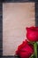 Blank vintage paper red bloomed roses on wooden board