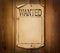 Blank wanted poster on wooden background