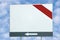 Blank white billboard copy space, red and grey bar and arrow, over bright summer cloudscape