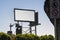 Blank white billboard in Los Angeles, California with vintage street lights in foreground