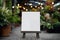 Blank white canvas on wooden easel in flower shop, mock up