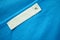 Blank white clothes tag label with XL size on new blue shirt