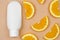 Blank white cosmetic tube and orange slices on a beige background. Cosmetics with orange. Orange Moisturizer