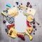 Blank white cutting board and various cheese with knife ,berries and honey