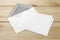 Blank white envelope and card on wooden background