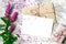 Blank white greeting card and envelope with purple wildflowers and vintage gift box