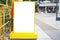 Blank white outdoor advertising  board with yellow frame on floor and blurred people, mock up  included clipping path