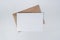 Blank white paper on the brown paper envelope. Mock-up of horizontal blank greeting card. Top view of Craft paper envelope on