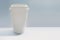 Blank white paper coffee cup mockup  isolated on a light background. Single-use disposable cup with no branding