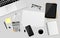 Blank white paper with digital tablet, notebook, pen, black metallic paper clips, calculator, coffee cup, USB Flash Drive,