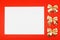 Blank white paper with golden holiday bows on red background