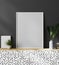 Blank white picture frame in modern stylish interior with dark gray wall and plants on the cupboard, 3d rendering