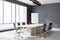 Blank white poster on the corner of modern sunny business meeting room with wooden table, marble floor and huge window with city