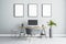 Blank white posters in black picture frame on light wall over stylish work place at home with monitor on wooden table, grey chair