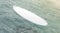 Blank white surfboard on water surface mock up, side view