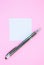 Blank white To Do List Sticker with pen. Searching information on the Internet..Close up of reminder note paper on the pink