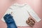 Blank white toddler girl`s long sleeved t-shirt on pink background with rose gold glitter ballet pumps and blue jeans