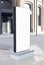 Blank white vertical pylon stand mockup brick building, side view