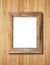 Blank wooden frame on bamboo wall