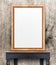 Blank wooden photo frame leaning at wood wall on vintage wood table,Template Mock up for add design or text