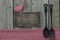 Blank wooden sign with red gingham heart and tablecloth and cast iron spoon and fork