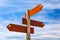 Blank wooden signpost with arrows over blue sky, just add your text. Guide post Signs On the bright sky background. Blank