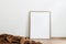 Blank wooden vertical picture frame mock-up on floor. Cinnamon linen plaid. White wall background. Empty copy space, no