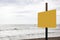 A blank yellow signboard on a beach with space for your text and clipping path for the signboard