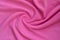 The blanket of furry pink fleece fabric. A background of light pink soft plush fleece material with a lot of relief fold